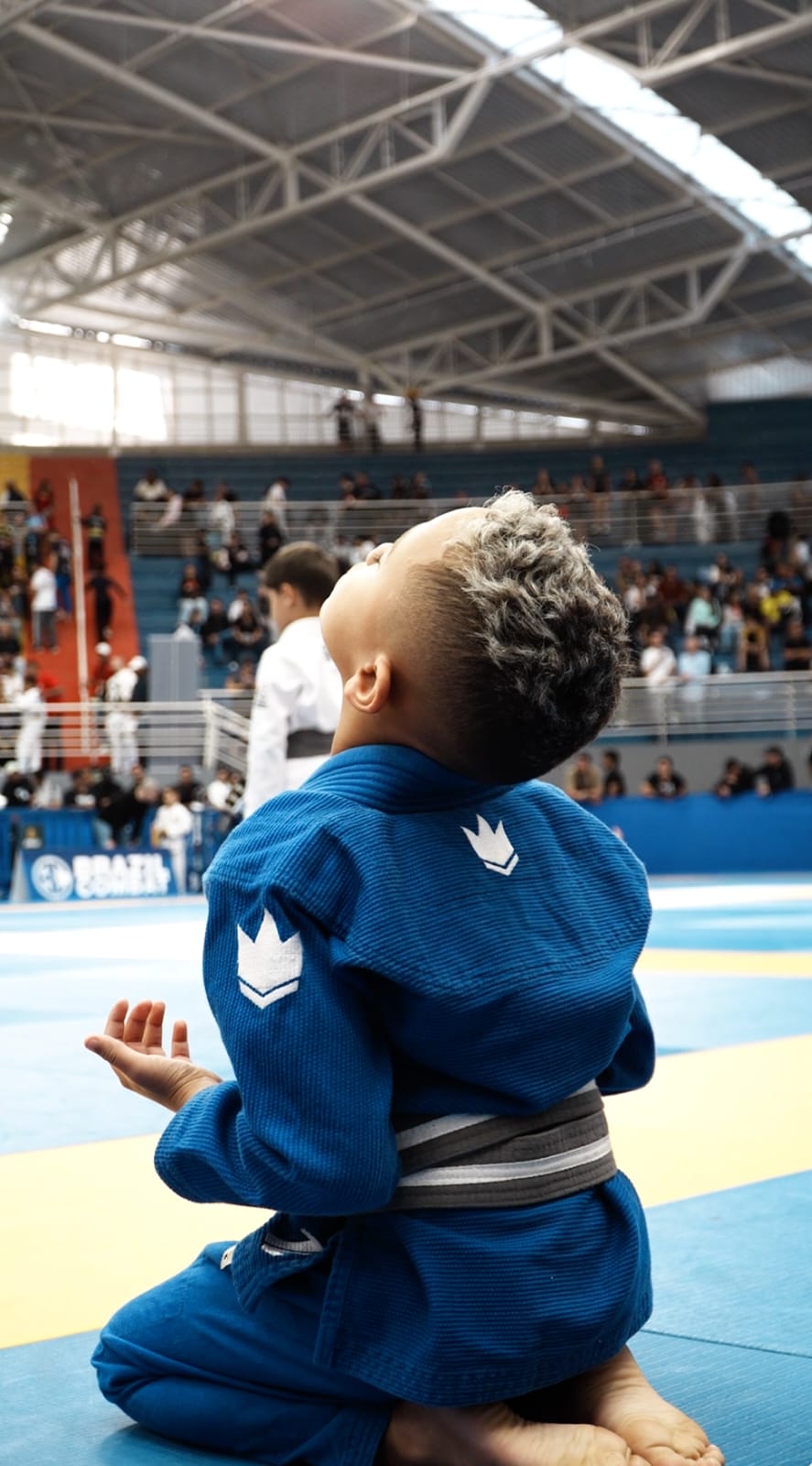 Pedrinho ajoelhado no tatame